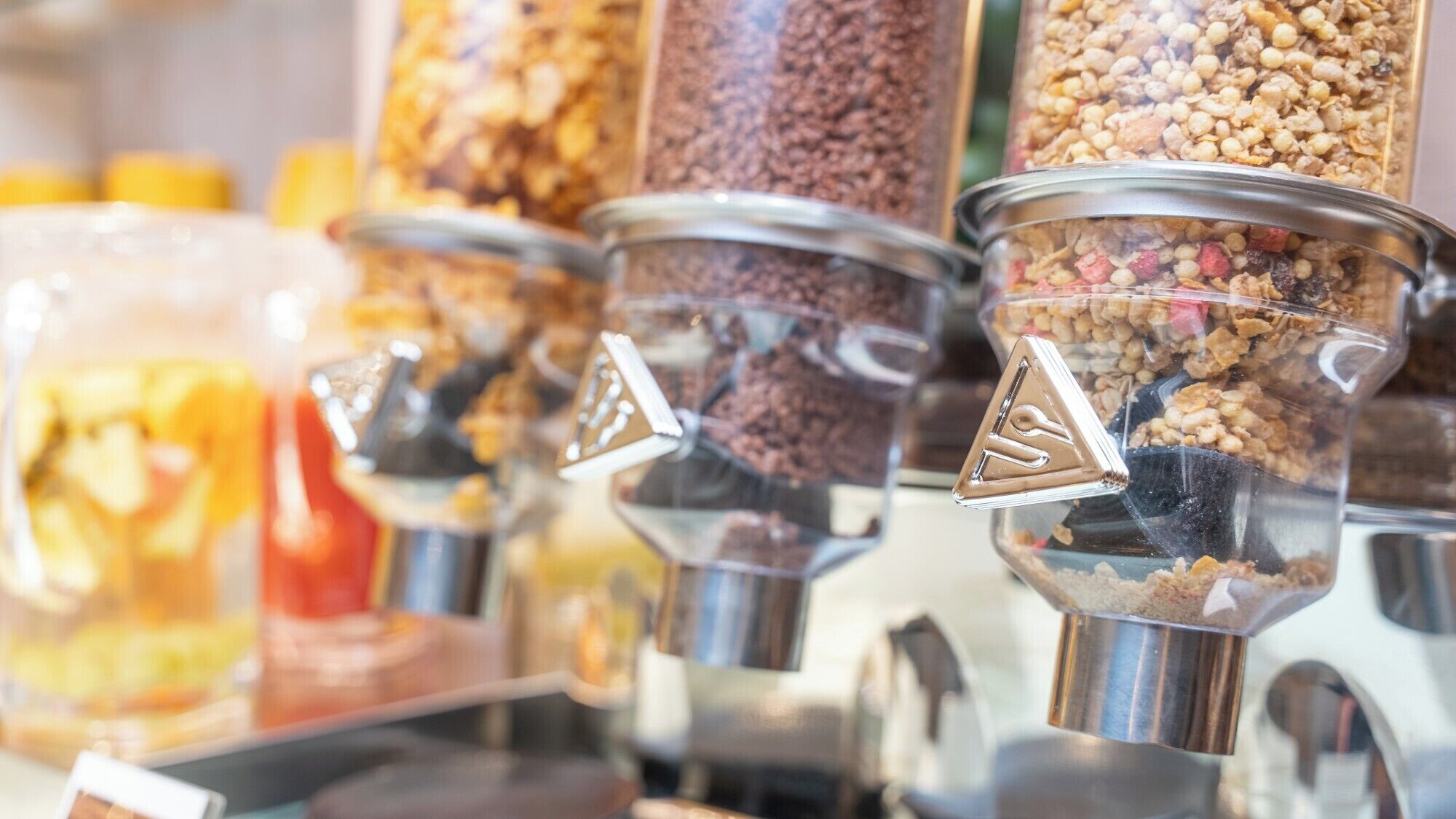 A variety of food dispensers with different types of snacks.
