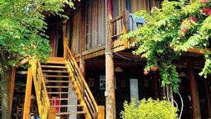 A wooden building with a balcony, a wooden staircase, and a hanging light fixture. - The L'anmien Bui Vien (Ho Chi Minh City)