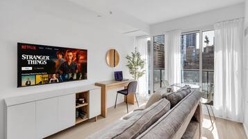 Deluxe Suite, 1 Bedroom, Non Smoking, City View | Living area | 50-inch flat-screen TV with digital channels