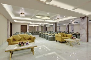A spacious hotel lobby with seating arrangements, chandeliers, and a marble floor. - Vaishnavi Beacon Hotel Patna (Patna)