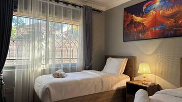 Family Apartment, Housekeeping, Lake View | Desk, laptop workspace, blackout curtains, iron/ironing board