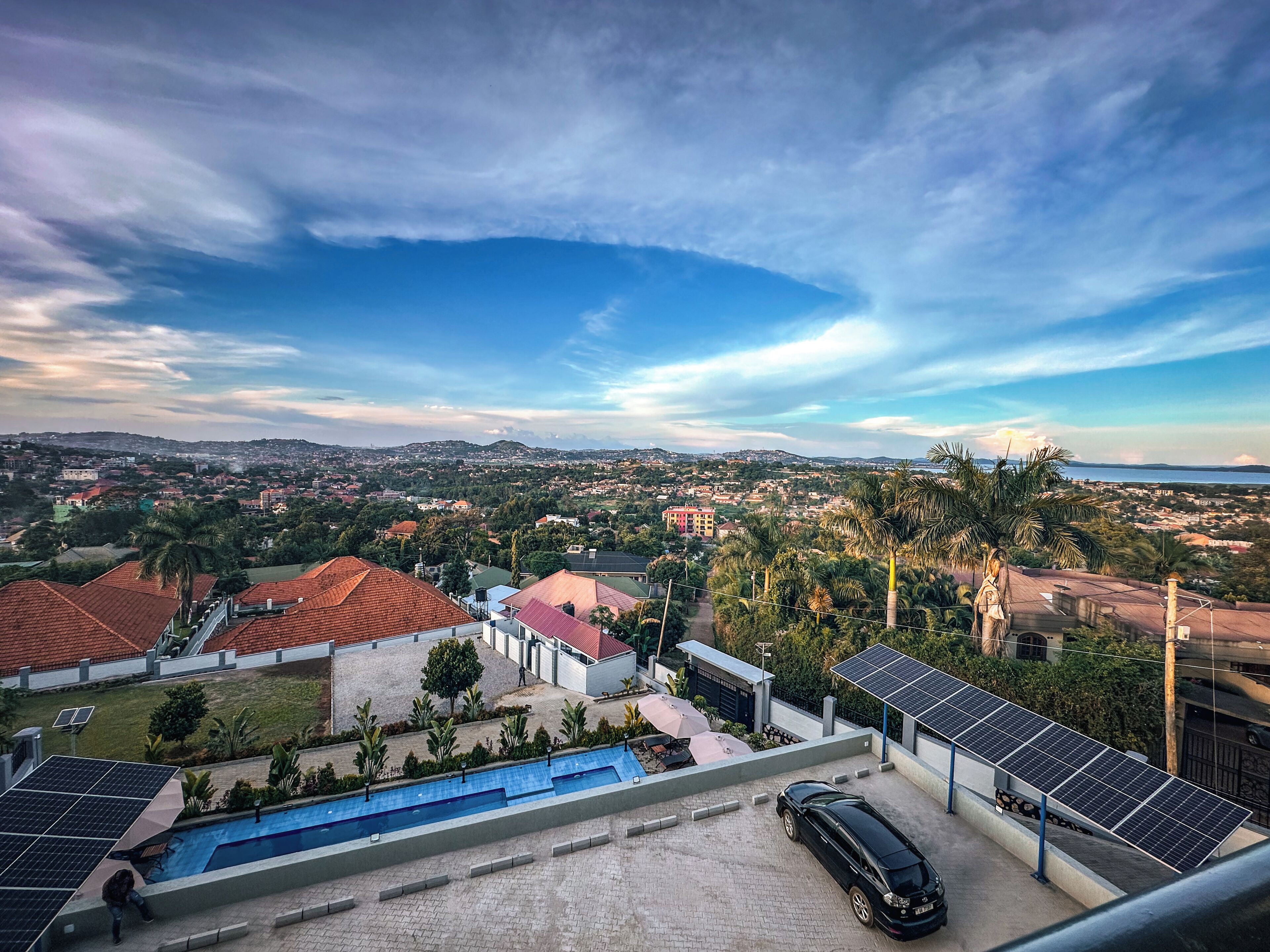 A residential area with houses, a swimming pool, and solar panels.
