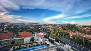 A residential area with houses, a swimming pool, and solar panels.