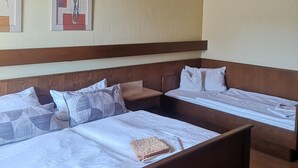 A hotel room with a wooden ceiling, two beds with headboards, a hanging light fixture, and two framed artworks on the wall. - Gasthof zur Post Weiding (Weiding)