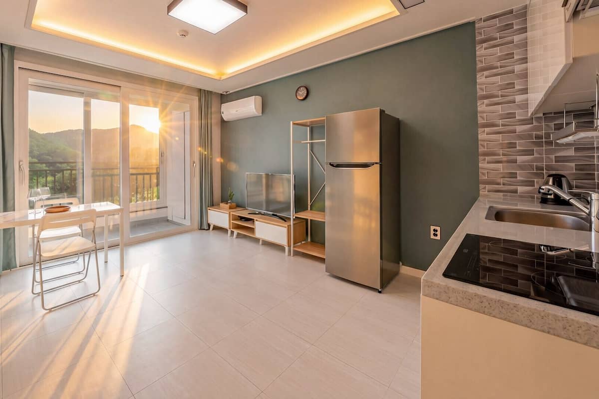 A modern kitchen with a refrigerator, stove, and sink.