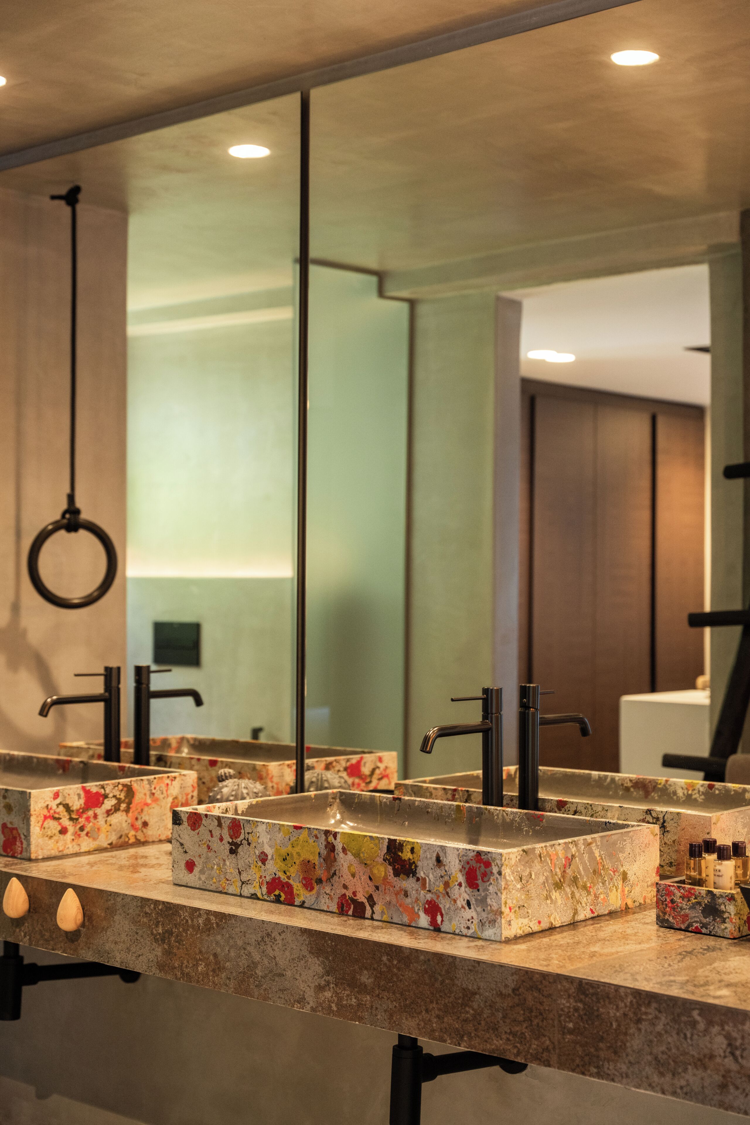 A bathroom with a large mirror, two sinks, and a ring light.