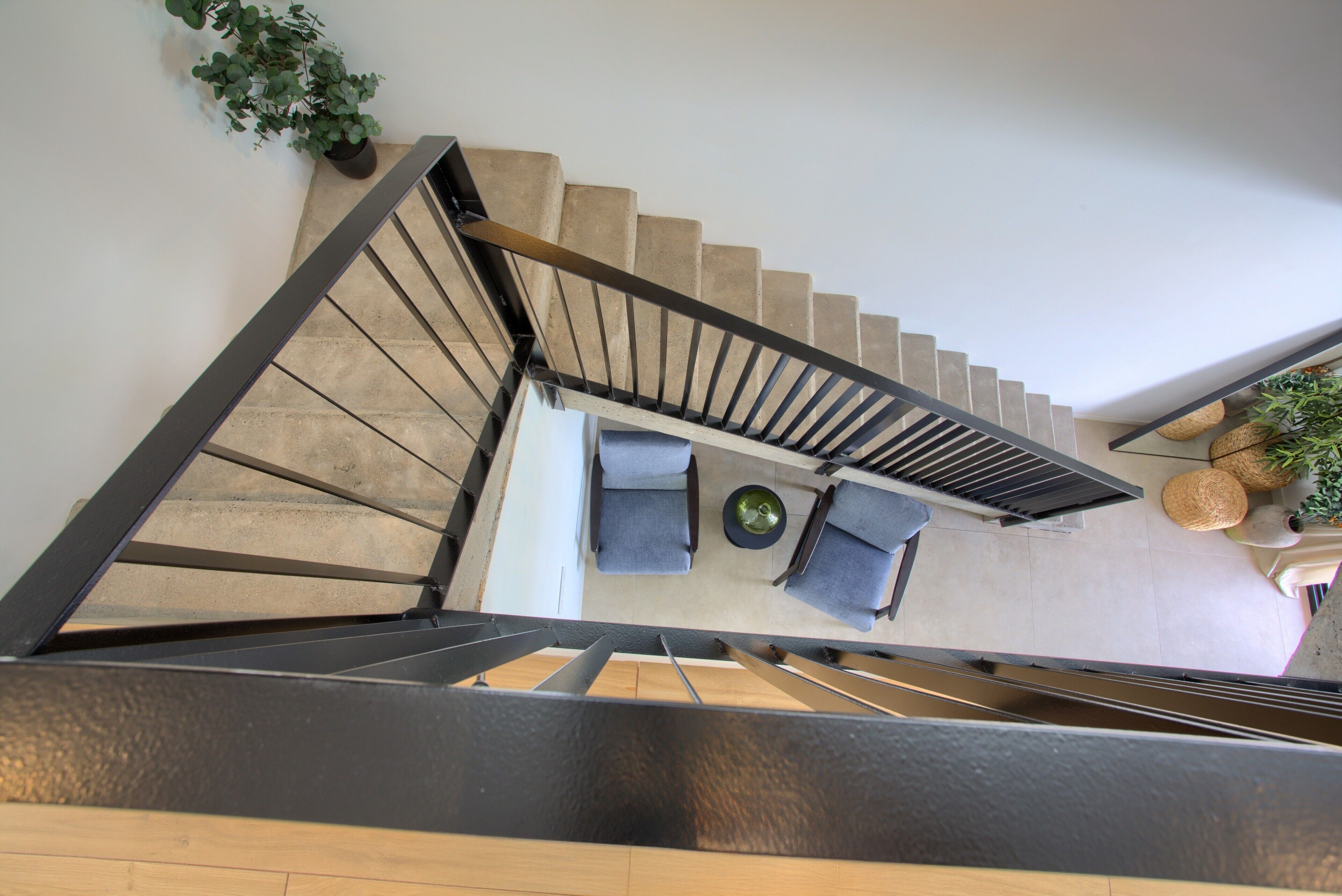 A staircase leading to a seating area with a table and chairs.