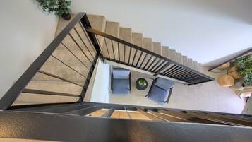 A staircase leading to a seating area with a table and chairs.