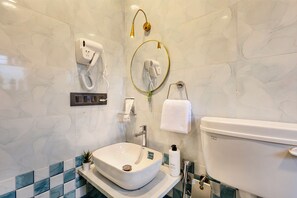 A bathroom with a white sink, a toilet, a hairdryer, and a towel rack. - Soulskape by Alaya Stays 4-BHK Villa (Karjat)