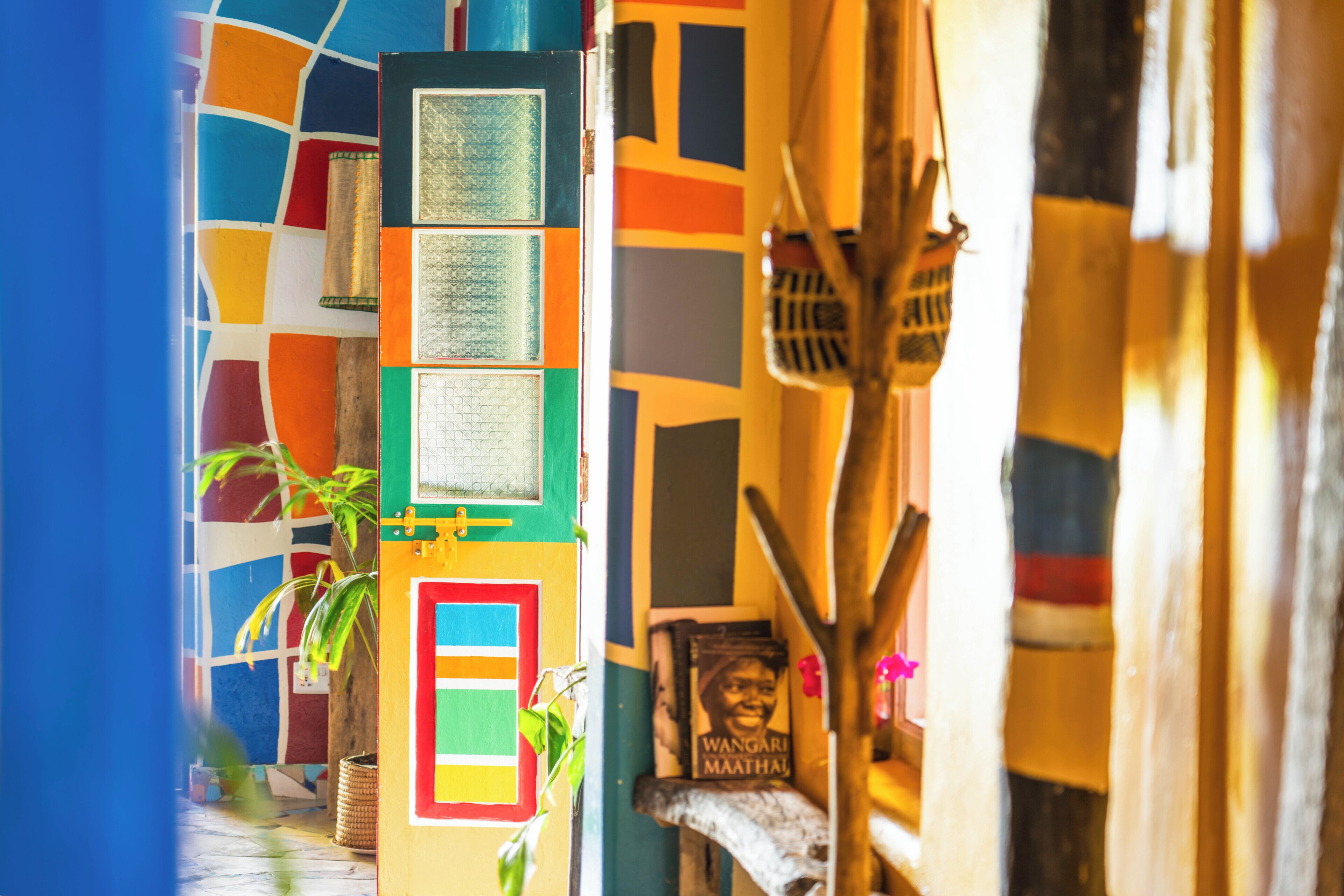 A colorful building facade with geometric patterns, a door, and a poster.