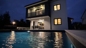 A modern two-story house with a swimming pool, a balcony, and a well-lit interior. - Villa Dani by Villas Guide (Gostinjac)