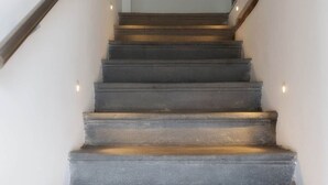 A staircase with wooden handrails and a painting on the wall. - Lake front house with lake view and garage (Pisogne)