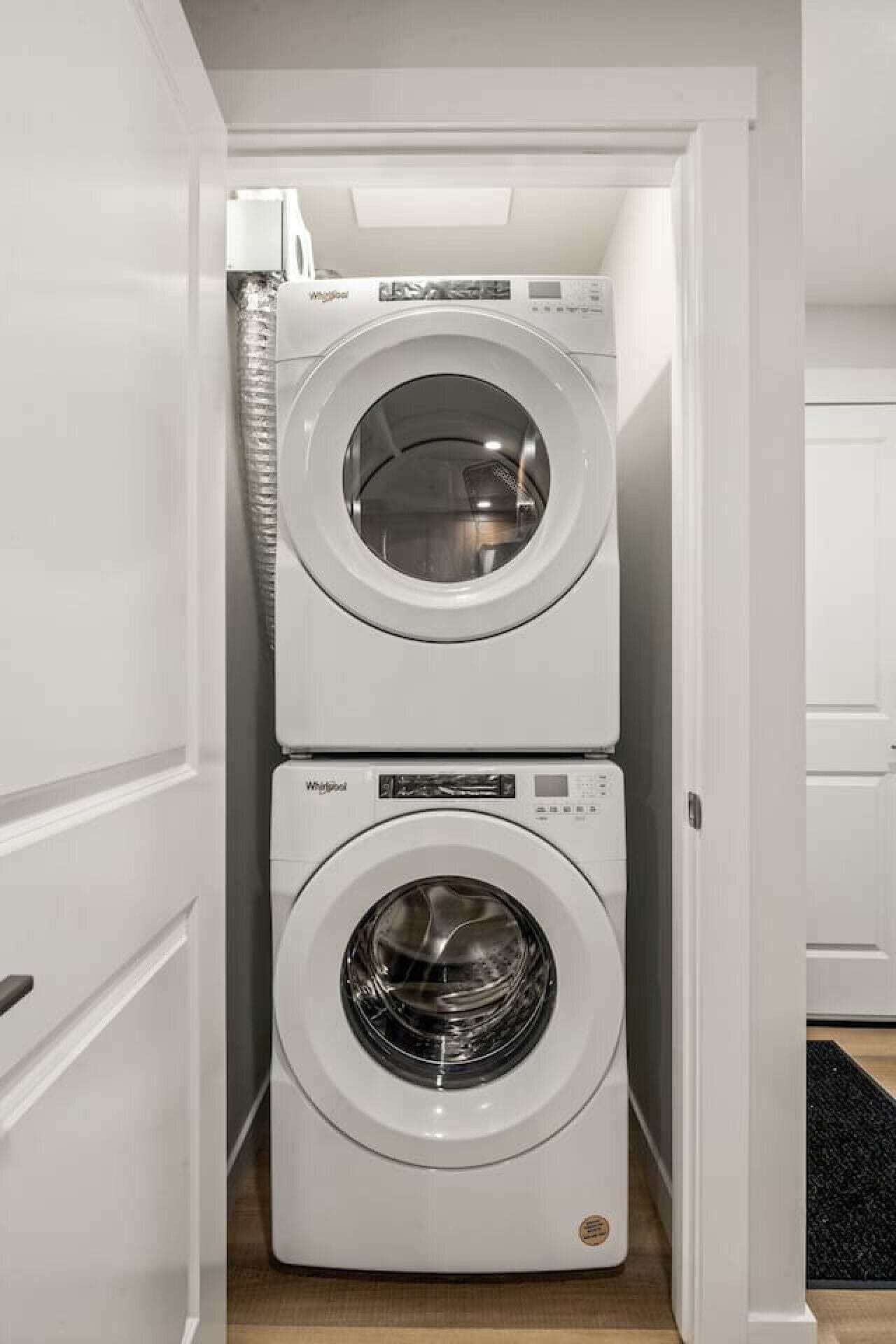 A laundry room with two stacked front-loading washing machines.