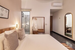 A hotel room with a bed, a mirror, a wardrobe, and a bathroom visible through an open door. - 7BR Grand Modern Villa, Private Pool Estate (Krong Siem Reap)