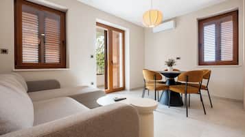 Superior Apartment, Balcony, Mountain View | Living area | 90-cm Smart TV with cable channels