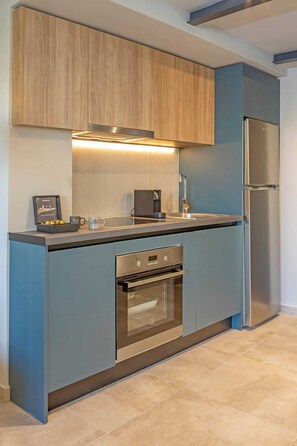 A modern kitchen with a built-in oven, a stainless steel refrigerator, and a coffee maker. - Amarada Marina Loft Suite 2, Apartment (Rhodes)