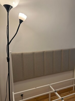 A bed with a headboard, a nightstand, and a lamp. - La Folie Appartement r Publique Marais (Paris)