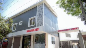 A two-story building with a sign reading 'Shubharambh Greens.' - Shubharambh Green's (Vrindavan)
