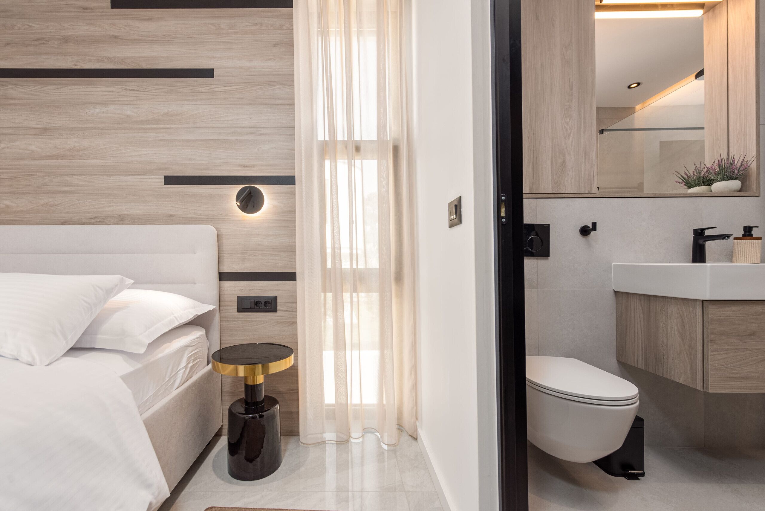 A modern bathroom with a toilet, sink, and shower area.