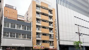 A multi-story building with a ground-floor commercial space and upper residential units. - Urban Plaza (Osaka)