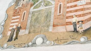 A mural with architectural elements and figures, including a date and signature.