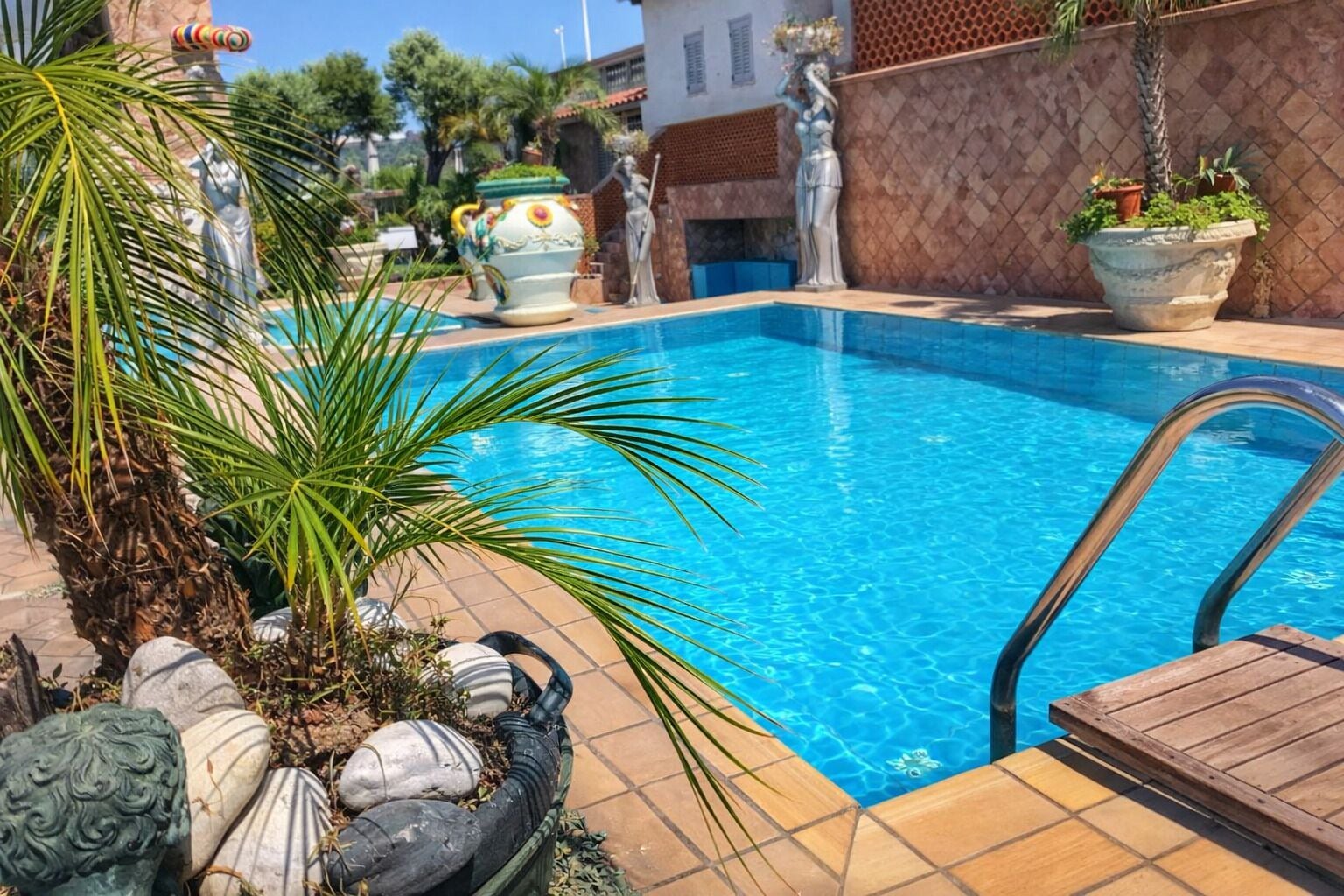 Seasonal outdoor pool, open 10:00 AM to 6:00 PM, pool umbrellas