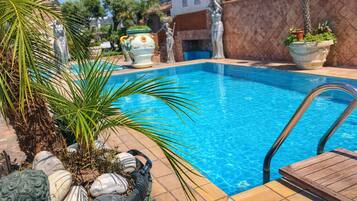 Seasonal outdoor pool, open 10:00 AM to 6:00 PM, pool umbrellas
