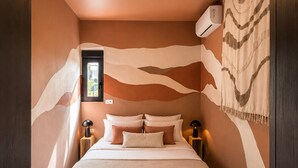 A bedroom with a bed, nightstands, a wall-mounted air conditioner, and a window. - House - 2 private suites - cosy - 2'Monaco and port (Beausoleil)