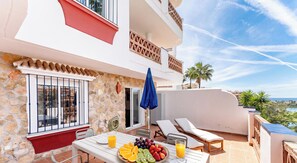 A balcony with a table set for breakfast, outdoor seating, and a view of the sea. - Riviera Paradise | Terrace, Pools & Views REF902 (La Cala de Mijas)