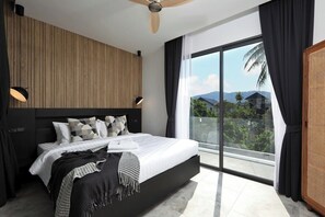 A modern bedroom with a large bed, a ceiling fan, and a balcony with a view of the outdoors. - Modern 4BR Villa with Pool | Rawai | Capital Pro (Rawai)
