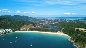 A coastal town with a beach, boats, and a mountainous backdrop. - 3BR Pool Villa Kokyang Rawai | Capital Pro (Rawai)