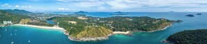 A coastal landscape with a beach, clear waters, and a hilly terrain. - 3BR Pool Villa Kokyang Rawai | Capital Pro (Rawai)
