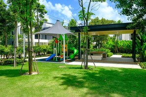 A playground with slides and a covered seating area. - 3BR Townhouse Near Bangtao Beach | Capital Pro (Tambon Choeng Thale)
