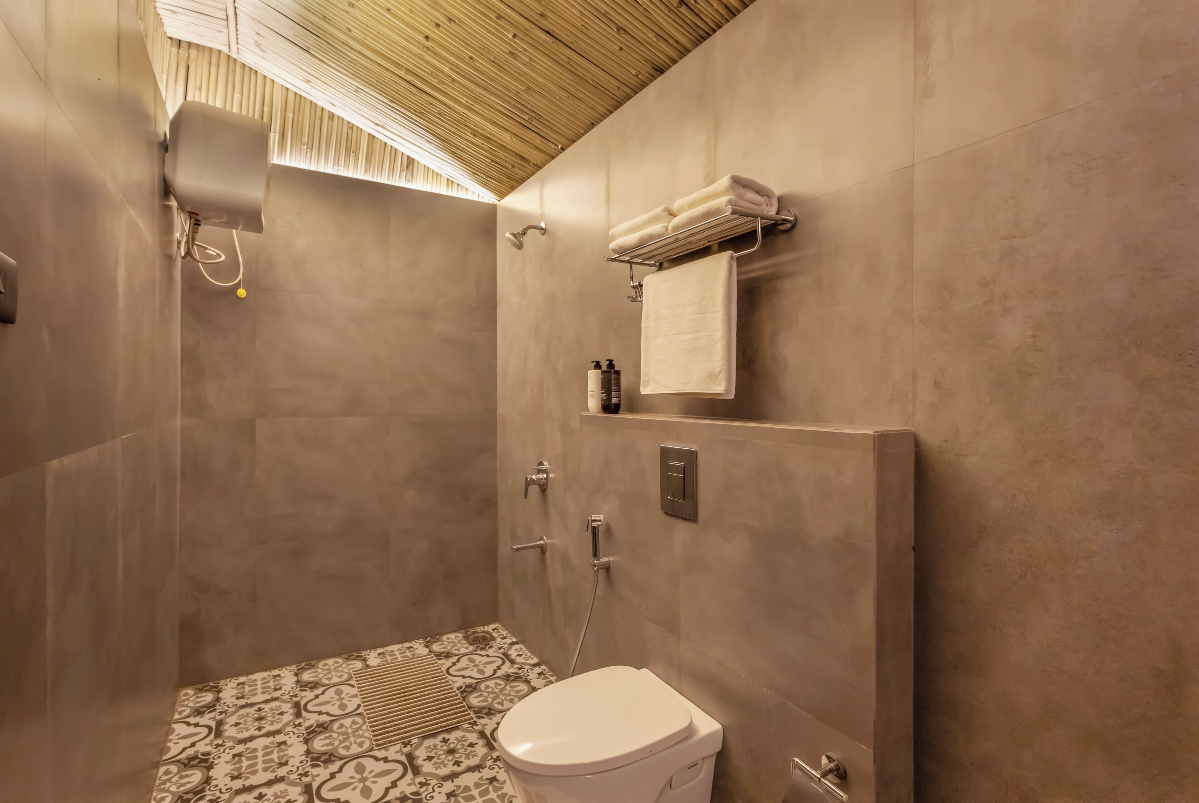 A modern bathroom with a shower, toilet, and a towel rack.