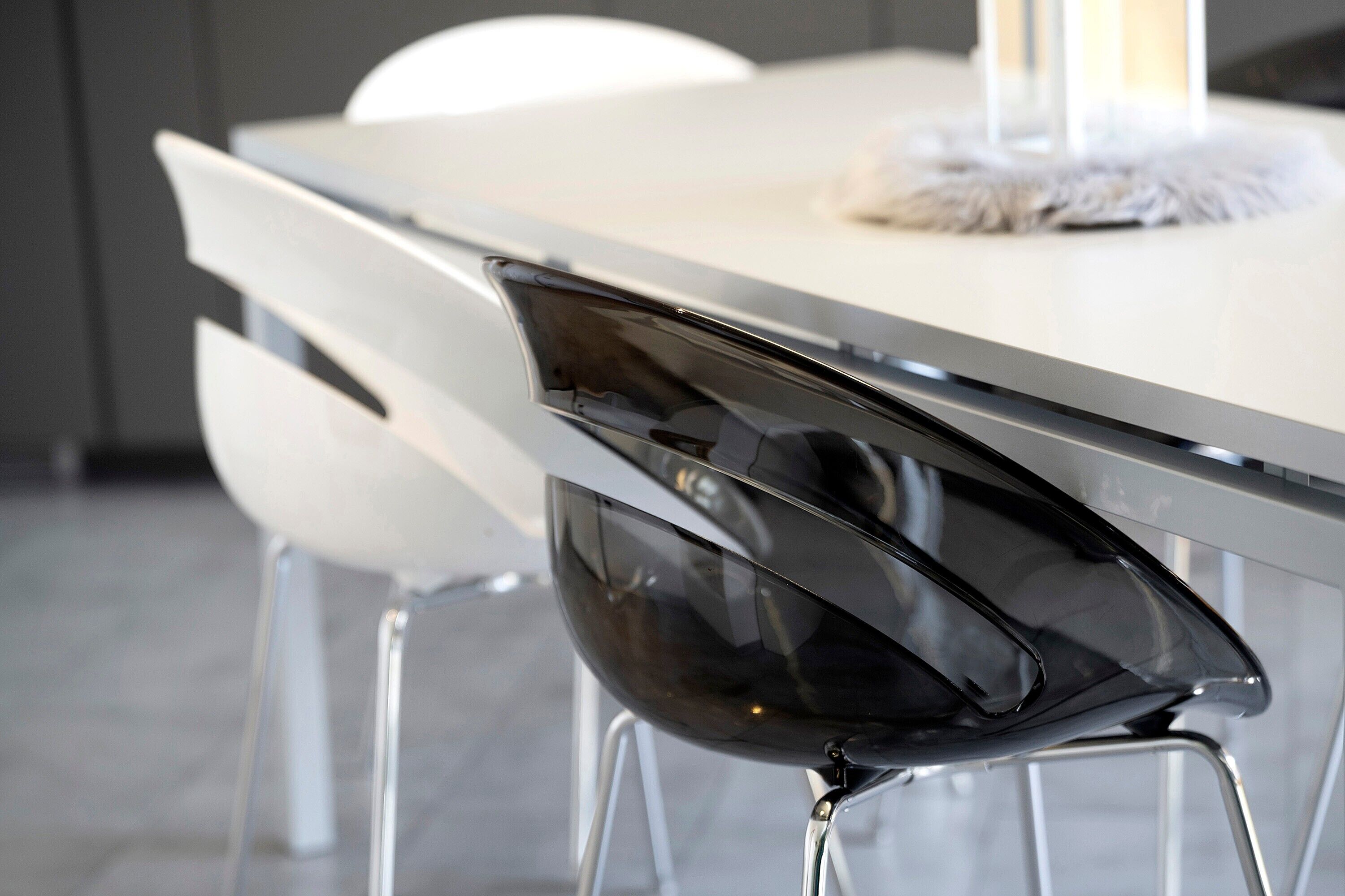 A modern dining table with a sleek black chair.
