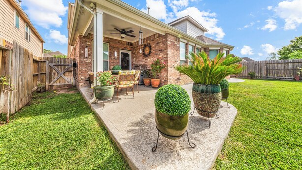 A house with a covered patio, outdoor furniture, and potted plants. - Cypress - Private Bedroom in Shared Home (Cypress)