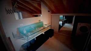 A bathroom with a glass sink, a mirror, and a shower. - Attic Boutique May (Bergamo)