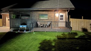 A two-story house with a covered porch, a garage, and a well-maintained lawn.