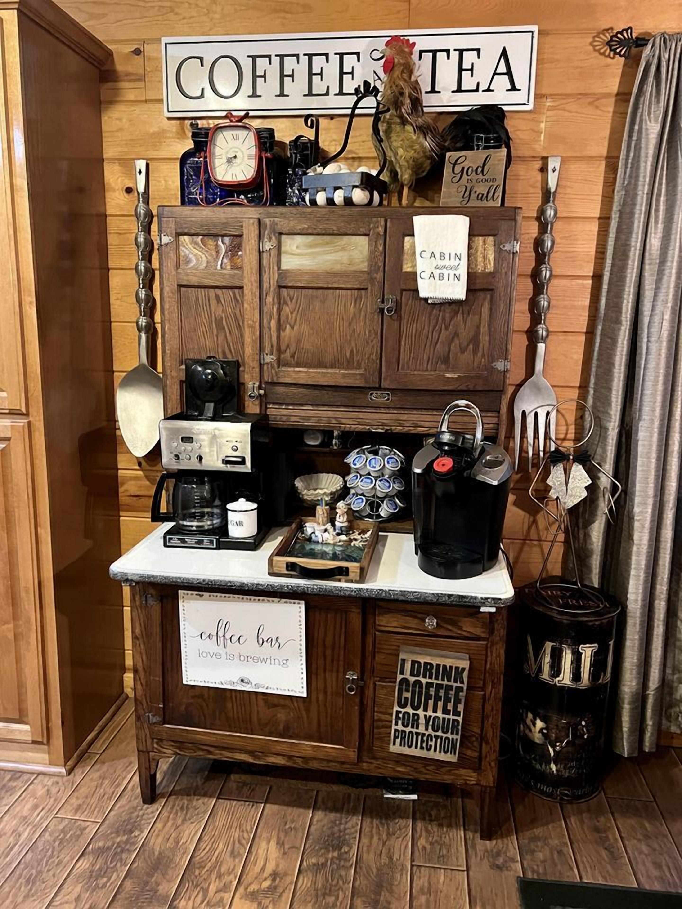 A coffee station with a sign reading 'COFFEE TEA,' a rooster decoration, and vintage coffee-making equipment.