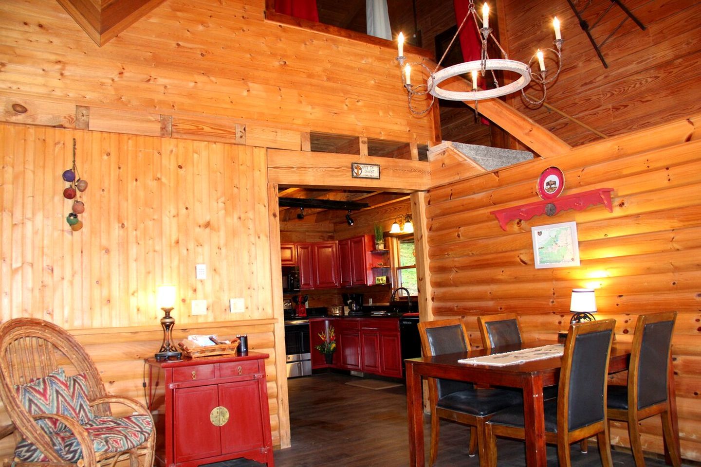 A wooden interior with a dining area, kitchen, and a cozy seating area.