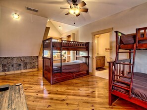 A room with a bunk bed, a desk, and a ceiling fan. - Beautiful, Luxury Cabin with Out-Door Hot Tub near Lake Burton in Northern Georgia (Clayton)