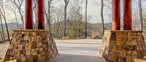 A covered outdoor area with stone walls and wooden benches.