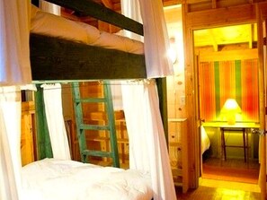 A room with a bunk bed, a ladder, a desk, and a chair. - Unique Cabin Vacation Rental for Large Groups on the coast of Lake Michigan near Saugatuck, Michigan (Fennville)