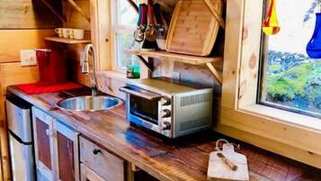 Coffee/tea maker, fridge, stovetop, cookware/dishes/utensils