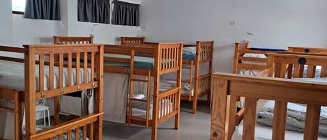 Un dormitorio con literas, un escritorio y una silla.