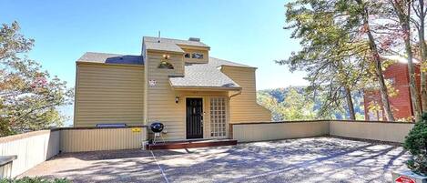A two-story house with a front porch, a garage, and a driveway.