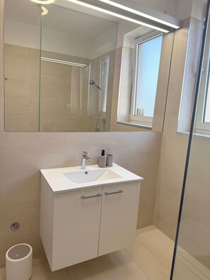 Shower, hair dryer, towels, soap