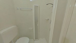 A small, enclosed shower area with a toilet and a glass door. - Relaxing sea Front Apartment (Lignano Sabbiadoro)