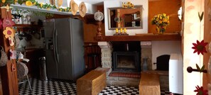 A kitchen with a refrigerator, stove, and checkered floor. - 85m² mountain house with 50 m2 terrace and panoramic view/3bedrooms (Alliat)