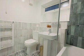 Combined shower/bathtub, deep-soaking bathtub, towels